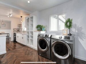 A renovated laundry room featuring new washer and dryer appliances and custom cabinetry by The Sioux Falls Handyman in Sioux Falls, SD.