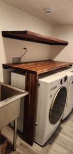 Custom wooden shelving and countertop installed in a laundry room by Peak2Peak Connect Handyman Services LLC in Arvada, CO.