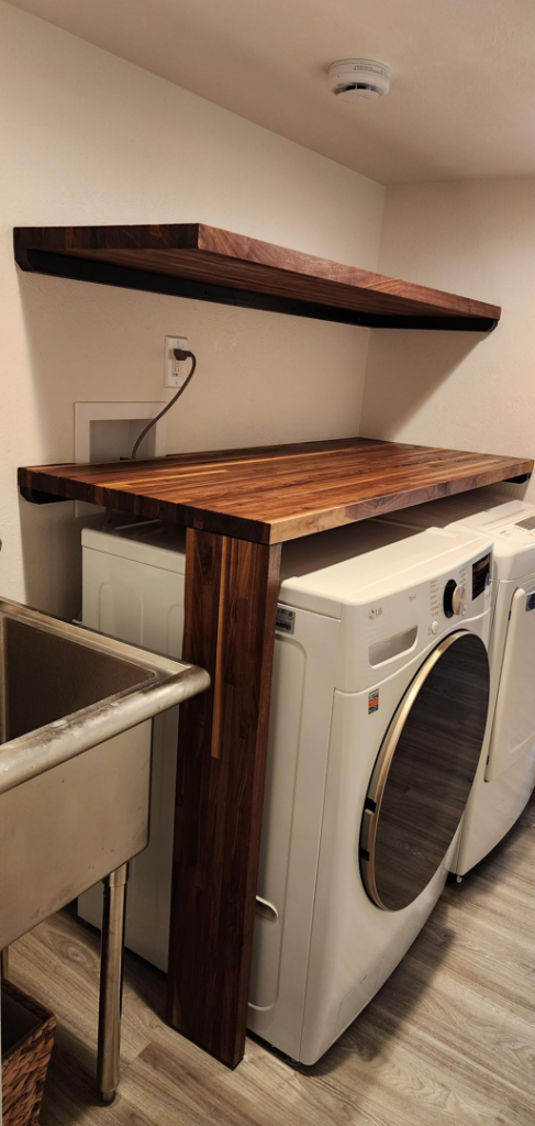 Custom wooden shelving and countertop installed in a laundry room by Peak2Peak Connect Handyman Services LLC in Arvada, CO.