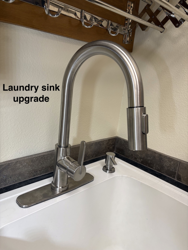 A modern brushed nickel faucet installed as part of a laundry sink upgrade by Handy Home Hero LLC in Bend, OR.
