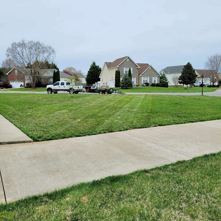 A truck and trailer with professional lawn care equipment from Home and Land Services in Clarksville, TN