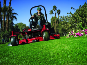 A person operating a riding lawnmower to provide professional lawn care service by Waltz Contracting LLC in Bloomington, IN