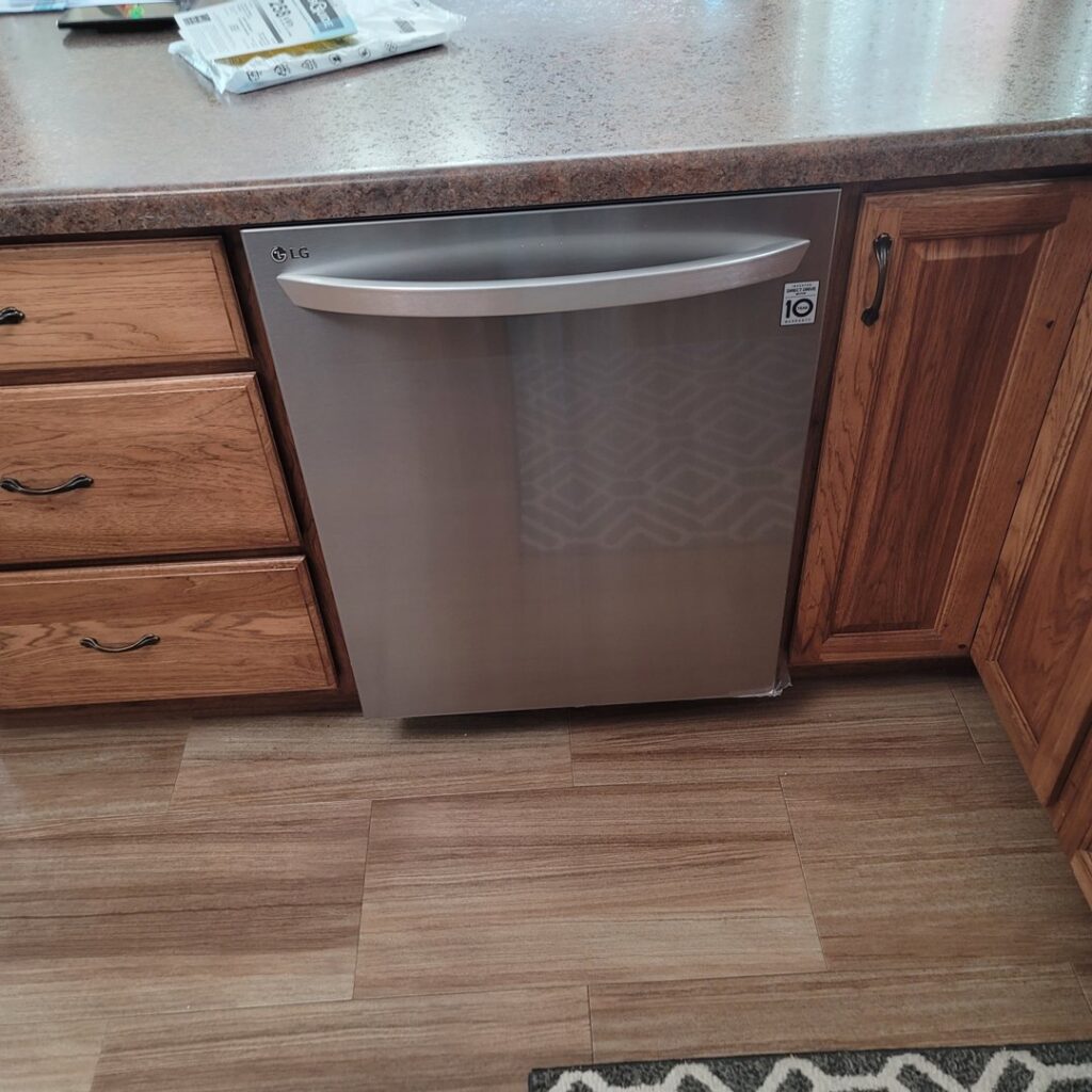 A newly installed LG dishwasher integrated into kitchen cabinetry by Amazing Handyman Services in West Fargo, ND