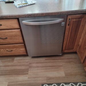 A newly installed LG dishwasher integrated into kitchen cabinetry by Amazing Handyman Services in West Fargo, ND