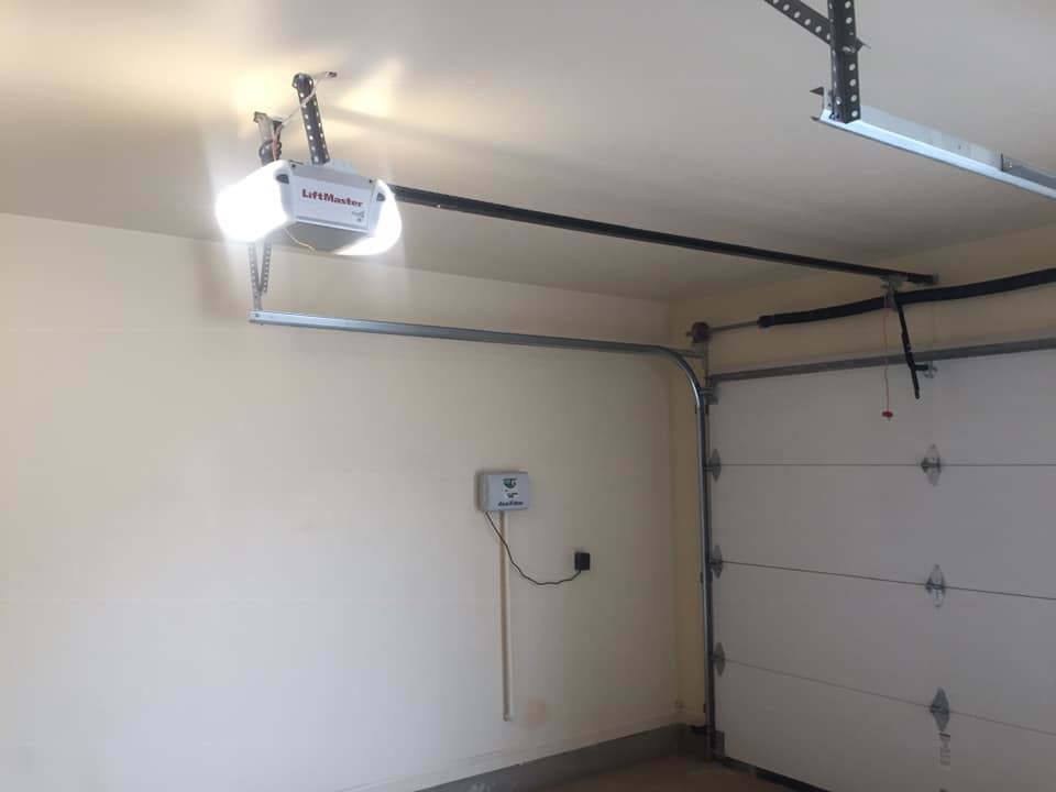 A LiftMaster garage door opener and white garage door installed by Big Red Overhead Door, LLC in Moore, OK.