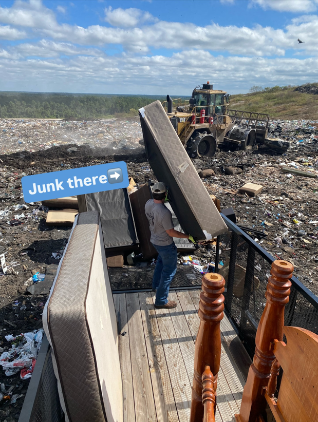 A Litter Hitters team member disposing of a mattress at a landfill as part of junk removal services in Jacksonville, FL.