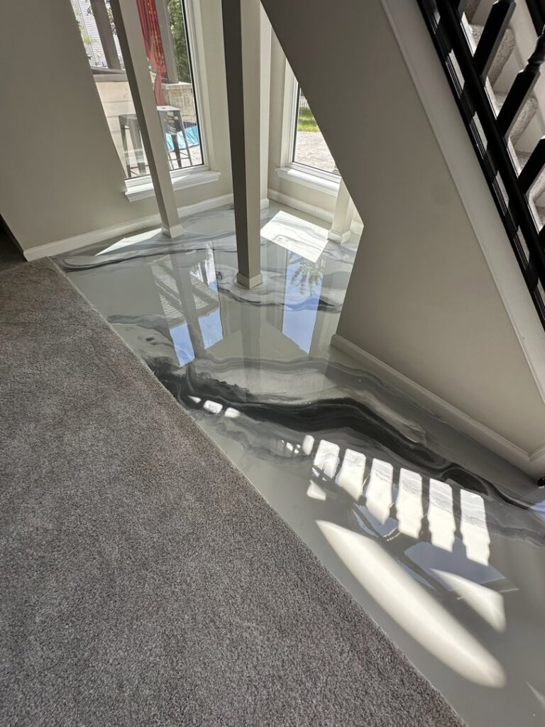 A bright living area showcasing a beautiful grey metallic epoxy floor installed by Donnelly J. LLC Epoxy in St. Charles, MO.