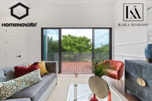 A bright living room with large sliding glass doors opening to a balcony, renovated by HomeNovate in San Antonio, TX.