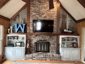 A beautifully finished living room featuring a remodeled fireplace and custom built-in shelves by Mr. Handyman of Olathe, Gardner in Olathe, KS.