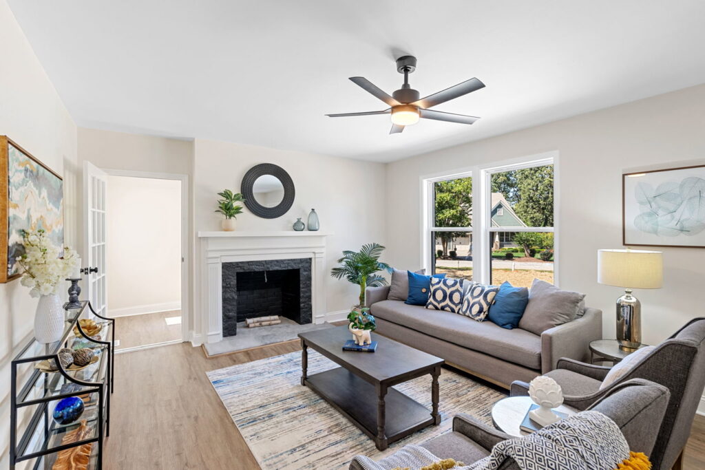 A living room with a newly installed fireplace surround and mantel by Heroic Builders LLC in Greenville, SC.