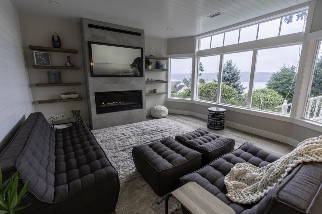 A renovated living room featuring a modern fireplace and built-in shelves by Gordon T. Jacob in Tacoma, WA