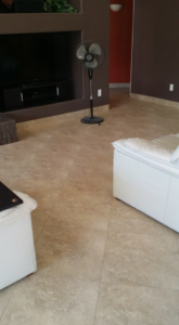 A living room with newly installed natural stone floor tiles by Gudiño's Tile and Natural Stone in Glendale, AZ