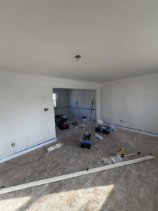 Living room flooring and painting in progress by Building Better Homes Management, providing handyman services in Cincinnati, OH.