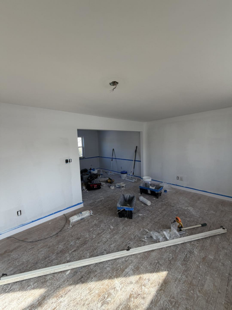 Living room flooring and painting in progress by Building Better Homes Management, providing handyman services in Cincinnati, OH.