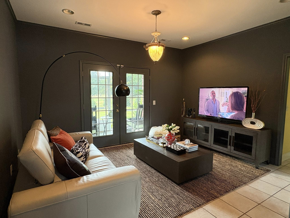 A beautifully painted living room with dark grey walls and modern furnishings by Carnelli Painting in Sumter, SC.