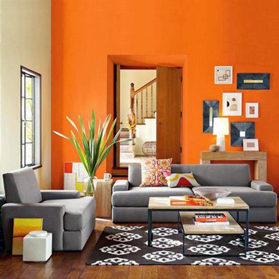A living room featuring vibrant orange interior painting by Surfaces By Design in Duluth, MN.