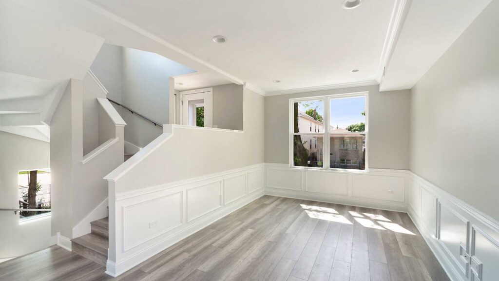 A renovated open-concept living room and kitchen area, completed by ETI Construction in Chicago, IL.