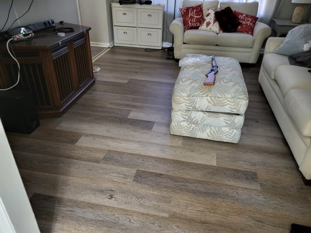 Living room with new LVP flooring installed by Gladiator Flooring LLC, a handyman service in Summerville, SC.