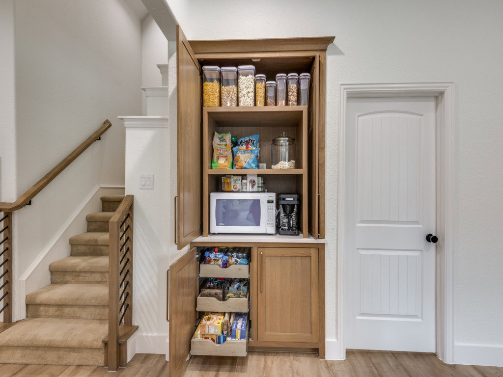 A renovated living room featuring a modern fireplace, built-in shelves, and a wall-mounted TV by DFW Improved in Plano, TX.