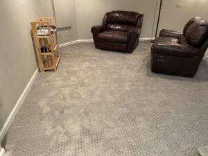 A living room with newly installed patterned carpet and two recliners, showcasing renovation work by RAW Renovation in Denver, CO.