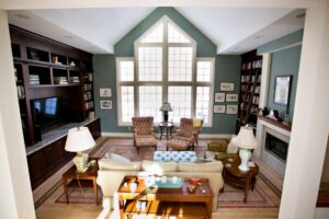 A spacious living room remodel with high ceilings, tall windows, and built-in shelving, by Northrup Remodeling in Minneapolis, MN