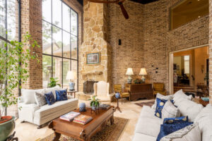 A spacious living room renovation featuring high ceilings and a stone fireplace by All Star Construction, Inc. in Houston, TX.