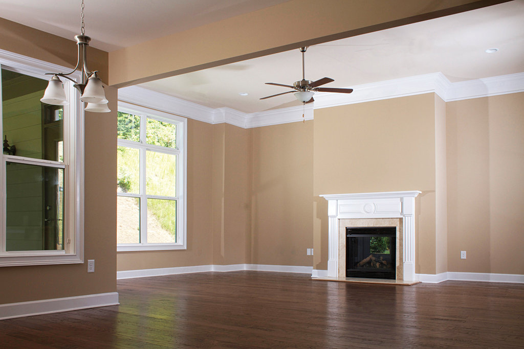 A newly renovated living room with a fireplace and fresh paint by Rapid Repairs and Renovations in Knoxville, TN.