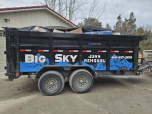A fully loaded and tarped junk removal trailer from Big Sky Junk Removal LLC in Billings, MT, ready for disposal.