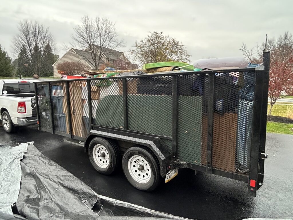 A large trailer fully loaded with various items of junk and debris, ready for hauling by Vatter Hauling Service in Lancaster, PA.