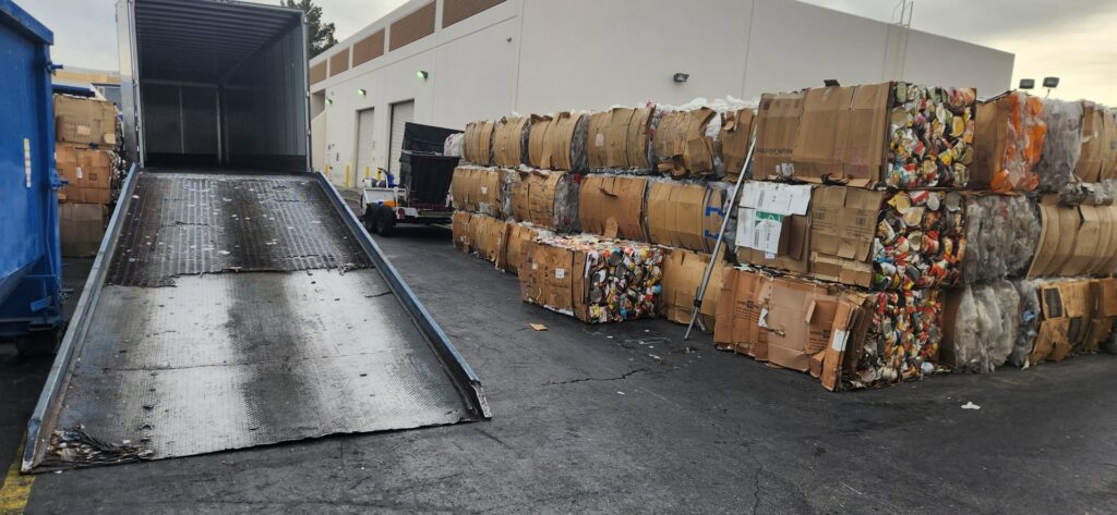 A loading dock with baled cardboard and plastic waste at RENUOil Of America, INC in Las Vegas, NV