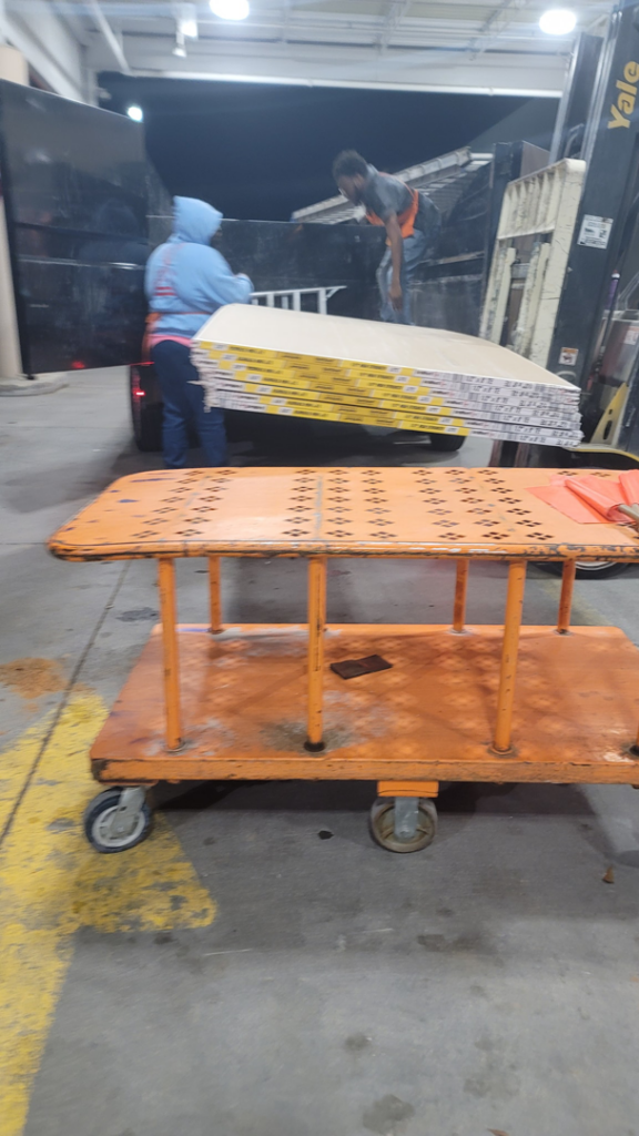 Workers loading drywall sheets onto a truck for a handyman or remodeling job by Cleaning Solutions & Remodeling Services LLC in Shreveport, LA.