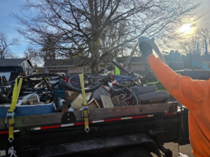 A Squirrel Squad LLC team member loading junk onto a trailer for removal services in Portland, OR.