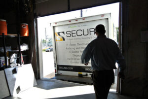 A Securis employee preparing to load or unload IT assets from a company truck at a loading dock in Greensboro, NC