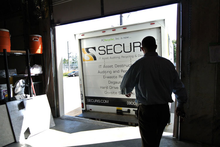A Securis employee preparing to load or unload IT assets from a company truck at a loading dock in Greensboro, NC