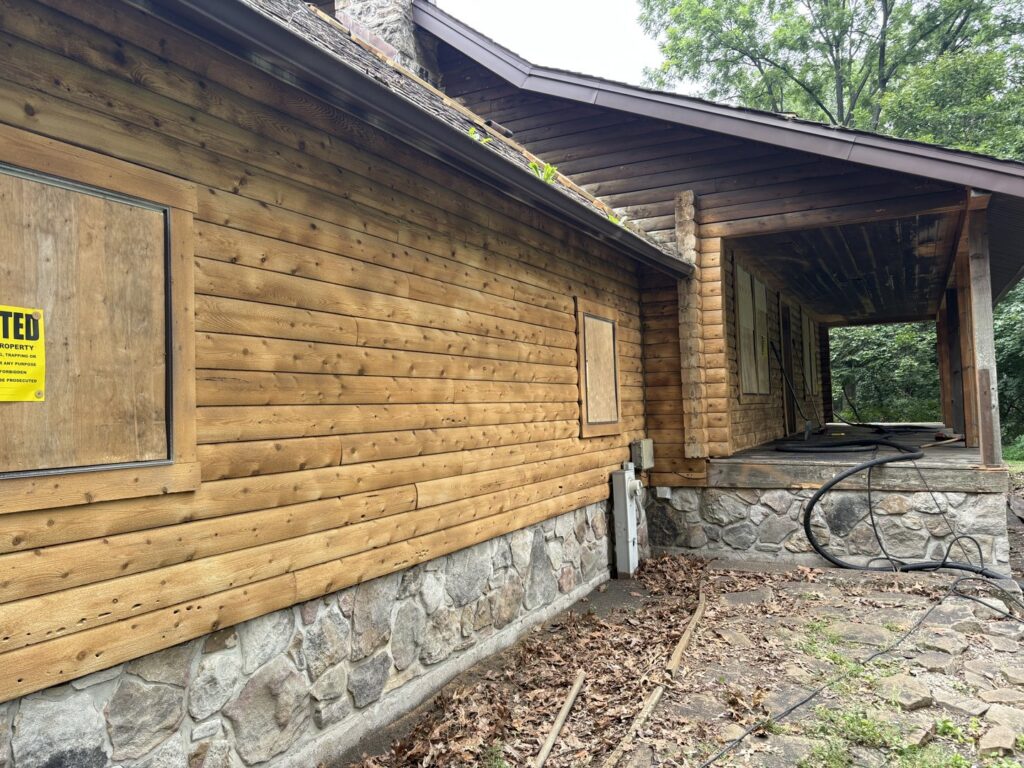 A log cabin exterior in need of renovation or restoration by Top Notch Sandblasting LLC in Randallstown, MD