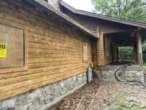 A log cabin exterior in need of renovation or restoration by Top Notch Sandblasting LLC in Randallstown, MD