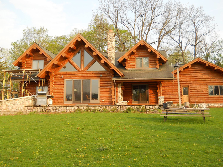 A log home with scaffolding set up for exterior maintenance by M & M Log Home Care in Traverse City, MI.