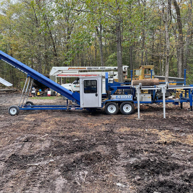 A log splitter and conveyor belt machine used for processing wood by Haslam Tree Service Inc. in Feura Bush, NY.