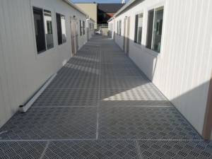 Long metal walkway system installed between two portable buildings by Northwest Access Products LLC in Castle Rock, WA.