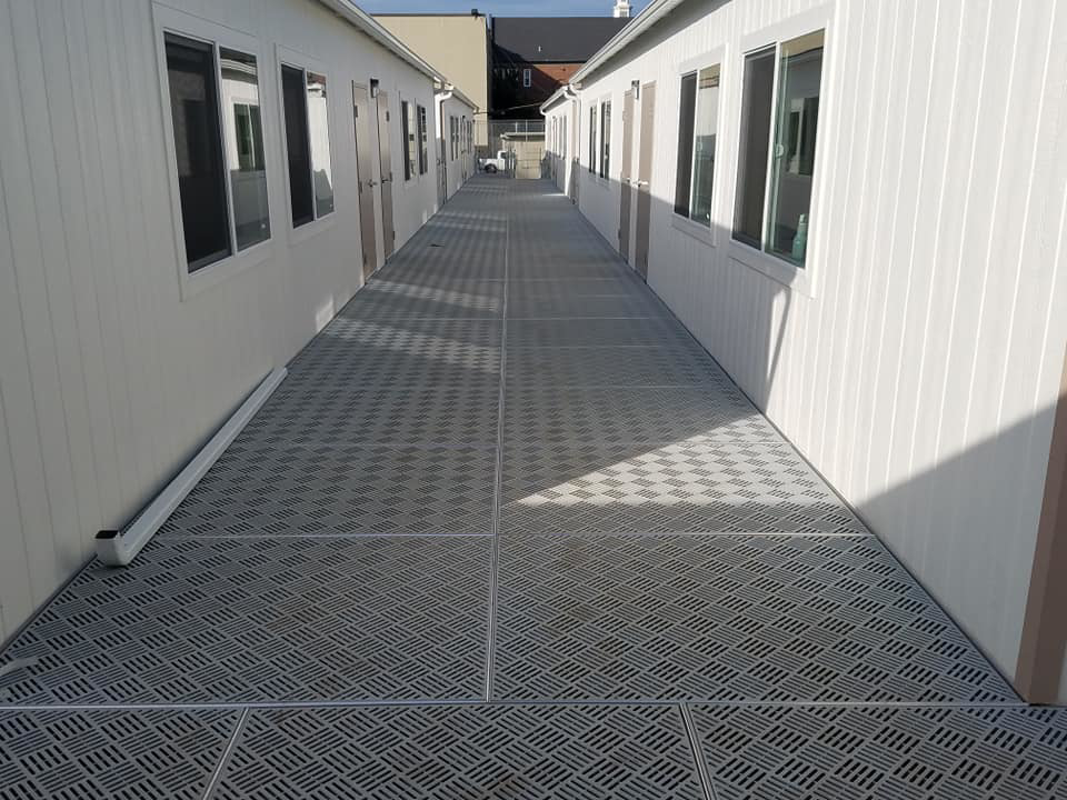 Long metal walkway system installed between two portable buildings by Northwest Access Products LLC in Castle Rock, WA.