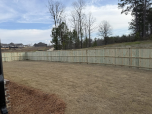A long section of newly installed wooden privacy fence by Swift Fencing Co. in Birmingham, AL.