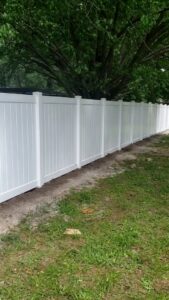 A long white vinyl privacy fence installed by NGC FENCE INC in Jacksonville, FL.