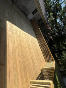 A long wooden deck featuring a ramp and stairs, expertly built by JD Handyman service LLC in Miami, FL.