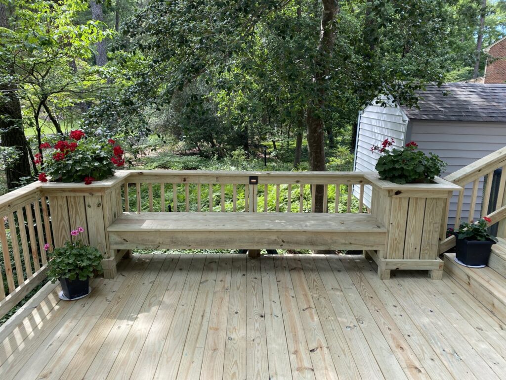 A long, newly installed wooden privacy fence with a decorative lattice top, built by Dutch Deck and Fence in Norfolk, VA.