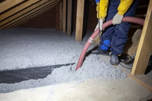 Loose-fill insulation being installed on an attic floor by Custom Insulation Company, Inc. in Worcester, MA