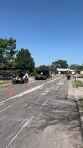 Lot clearing equipment, including a Bobcat loader and trailer, on a street for A. Matt Tree Service in Fort Worth, TX.
