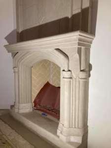 Lower section of a custom masonry fireplace with intricate mantel and hearth by Old Style European Stucco & Masonry in Brentwood, TN
