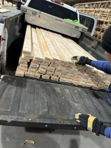 A truck bed loaded with lumber, ready for a handyman construction project by Jewell Services in Des Moines, IA.