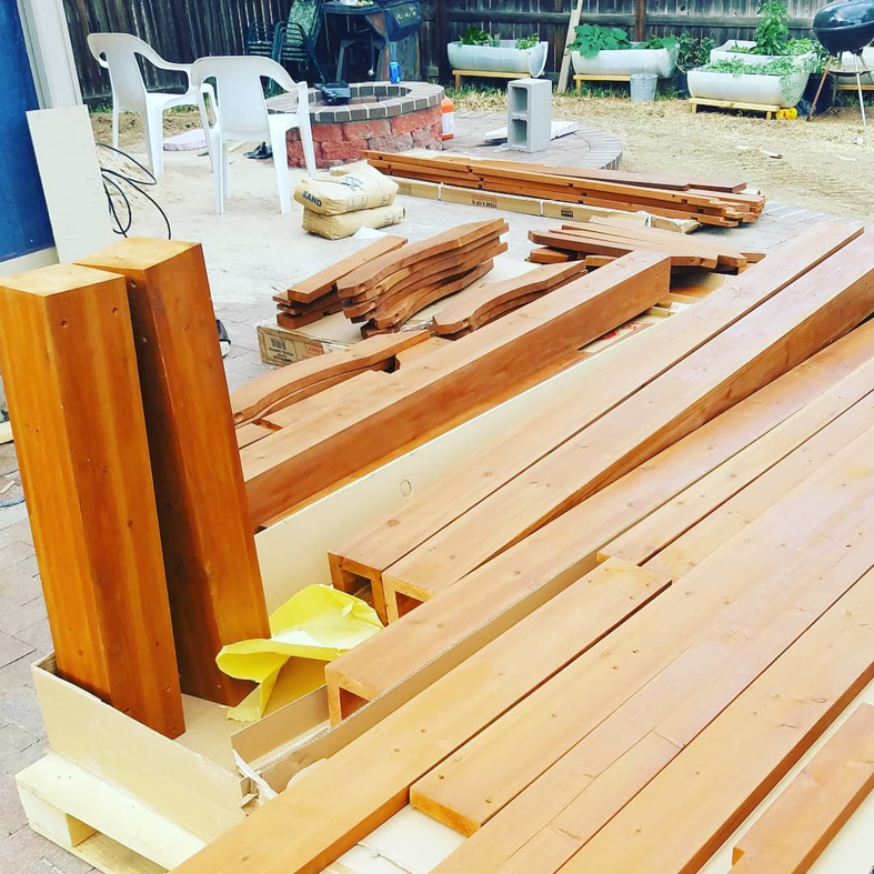 Lumber and construction materials laid out on a patio, ready for a gazebo project by Steveson Enterprises, Inc. in Golden, CO.
