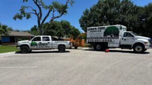 Two Luna's Tree Service trucks and a wood chipper parked on a sunny day in San Antonio, TX.